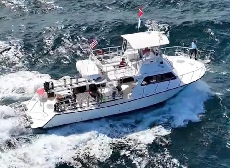 A dive boat underway on the ocean with its dive flag flying